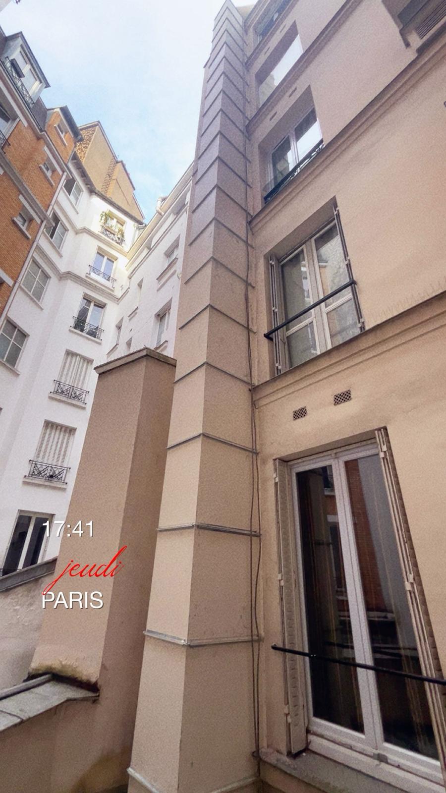 Conduit de ventilation sur façade immeuble parisien — cour intérieure